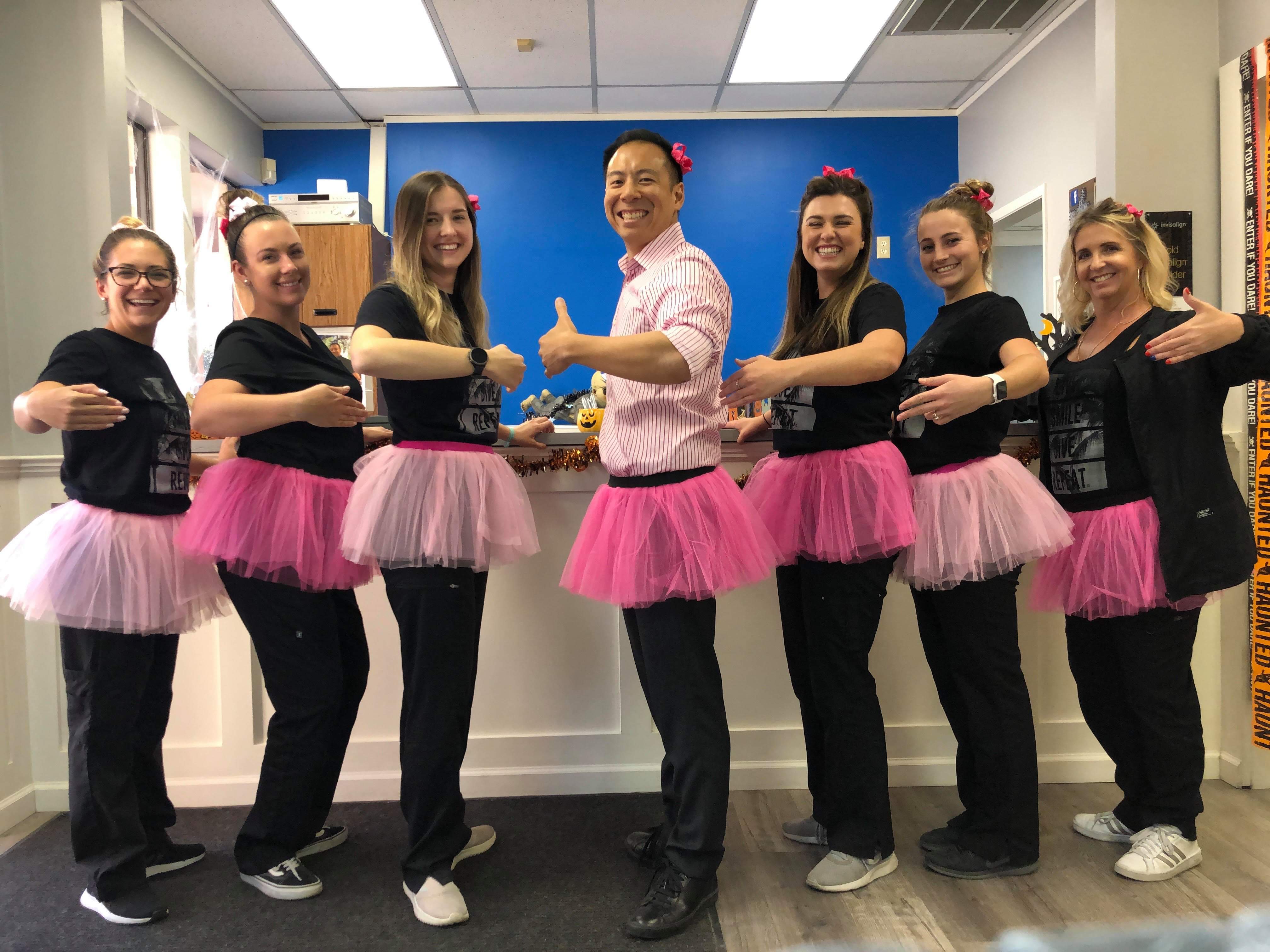 Dr. Jeff and team in pink tutus for Breast Cancer Awareness Month