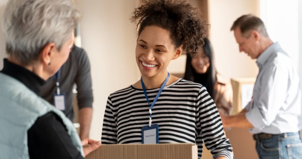 A woman volunteering at a holiday drive, one of the ways to give back to the community during the holidays in El Dorado Hills, CA