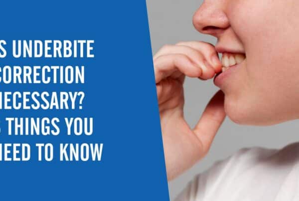 A side view of a person smiling and putting their fingers on their teeth with a text overlay that says "Is Underbite Correction Necessary? 8 Things You Need to Know"